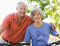 Photo of a man and woman on bicycles. Link to Life Stage Gift Planner Ages 60-70 Situations.