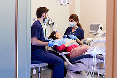 Dental students working. Links to Dual Dental Support story